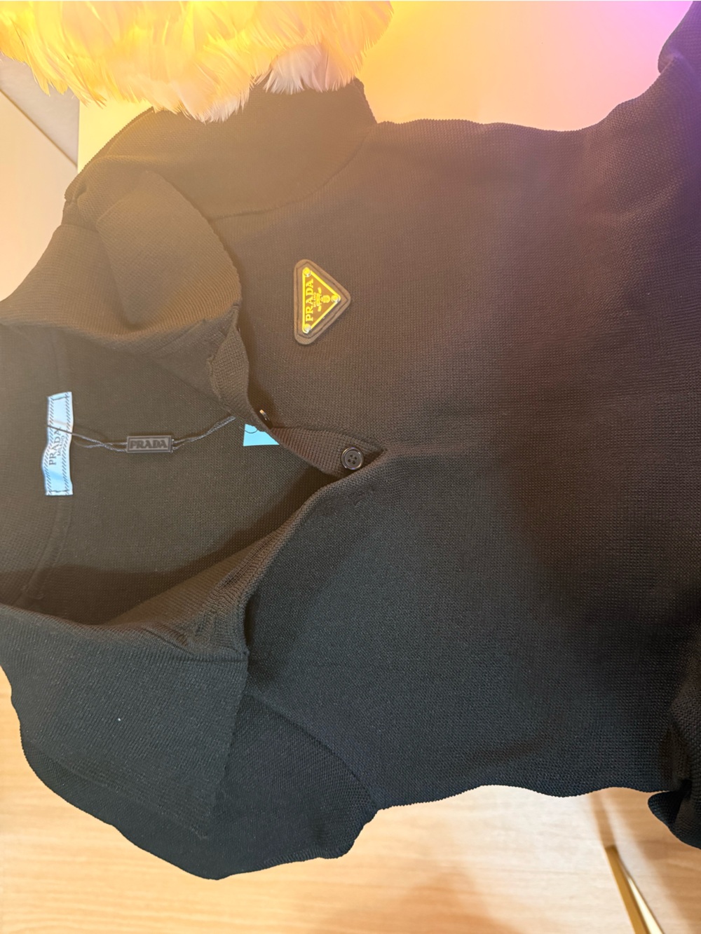 Prada Black Polo with a logo triangle.